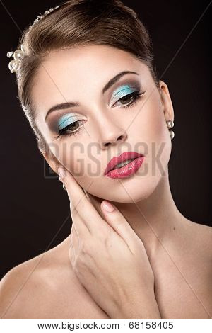 Beautiful girl with bright makeup and evening hairstyle.