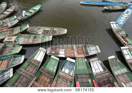 Tam Coc, Ninh Binh, Vietnam. Tour tourist boats in bay near Bich Dong 