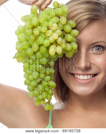 portrait of attractive  caucasian smiling woman isolated on white studio shot eating grapes
