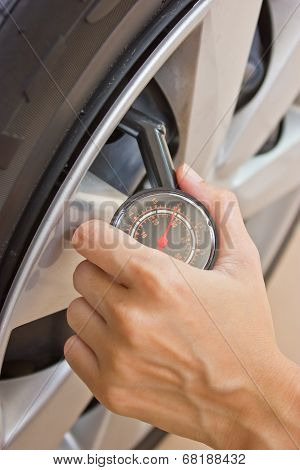 Hand Checking Tire Pressure.
