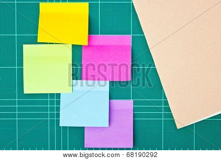 Colorful Sticky Notes Amd Notebook On Cutting Mat.