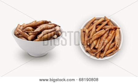 finger roots powder in a small bowl, isolated on white background, view from front and top