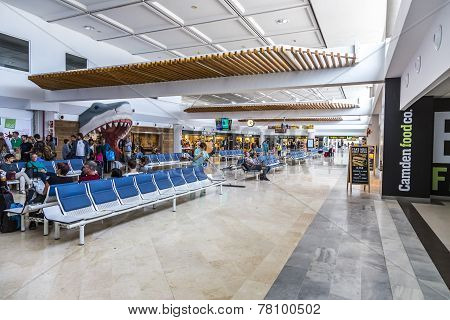 People Wait In Departure Hall At Airport Of Arrecife