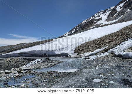 Couple On Motorcycle Riding In High Mountains