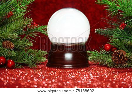 Christmas tree branches with empty snowglobe