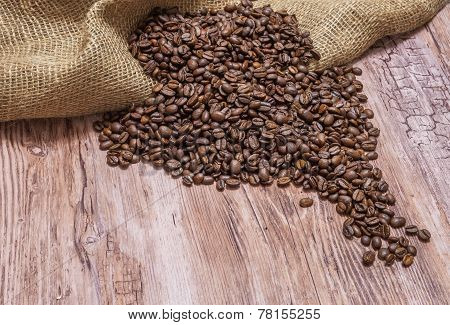 Coffee Beans spilled On old Wooden table
