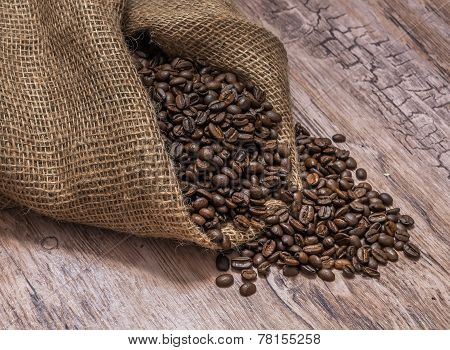 Coffee Beans spilled On old Wooden table