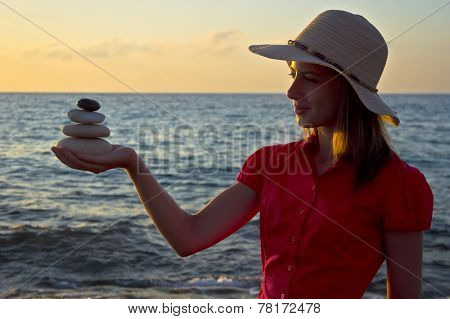 Young woman and balance at sunrise
