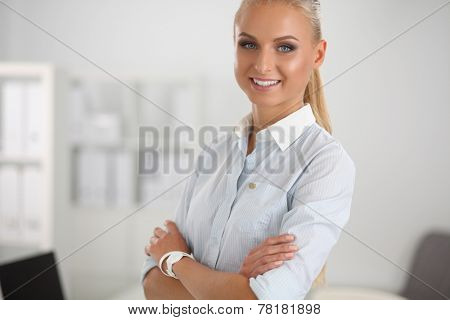 Attractive businesswoman with her arms crossed stnding