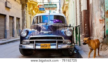 HAVANA - CIRCA FEBRUARY 2009: An old car in a back alleyway circa February 2009 in Havana, Cuba