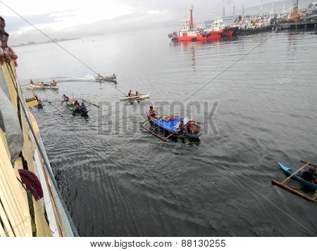 People in Outrigger Canoes in the Philippines