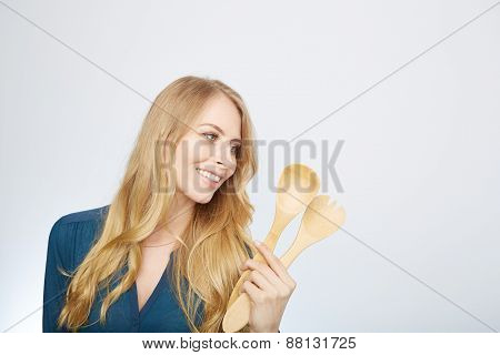 young woman holding a wooden spoon, isolated.