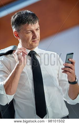 business man using phone at modern office space