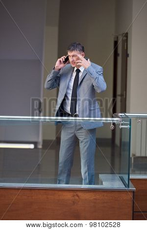 business man using phone at modern office space