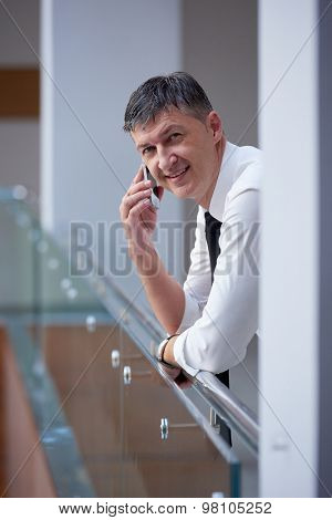 business man using phone at modern office space