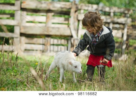 girl with lamb on the farm