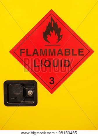 Flammable liquid cabinet door with warning sign and lock