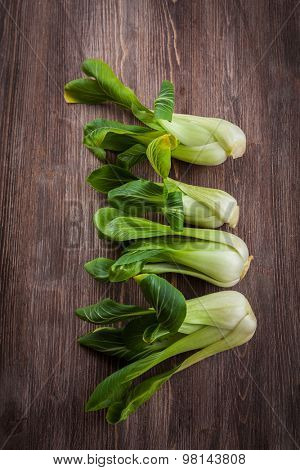 Chinese cabbage pak choi on wooden table
