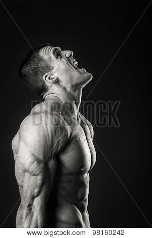 Strong, muscular guy on a black background.