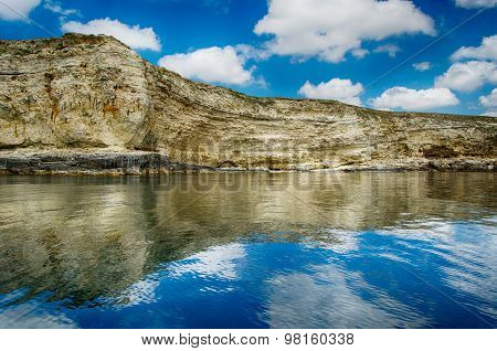 Seascape, Rocks Against A Blue Sky With Clouds