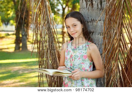 Cute Smiling Teen Girl Reading Book