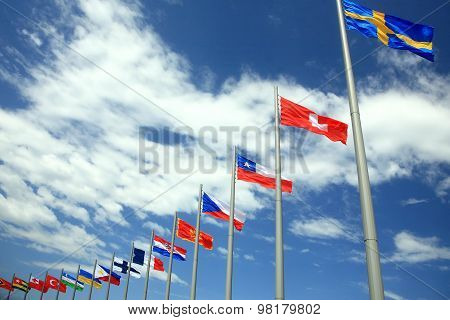 Flags Of The Different Countries Against The Sky