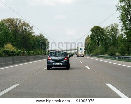 FRANKFURT GERMANY - APR 13 2017: Driver point of view pov of black Opel Corsa driving on German Autobahn Bundesautobahn or Federal Motorway highway with speed limits of 100 kmh electronic street sign