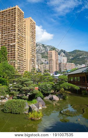 Monaco, Monte Carlo - September 17, 2016: Jardin Japonais, Japanese Garden view with residential buildings at the background.