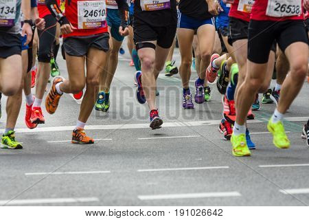 BERLIN - APRIL 02 2017: The annual 37th Berlin Half Marathon. Athletes are running. Legs of athletes close-up.