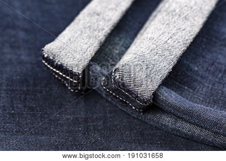 Denim blue jeans folded hemmed close up on with background
