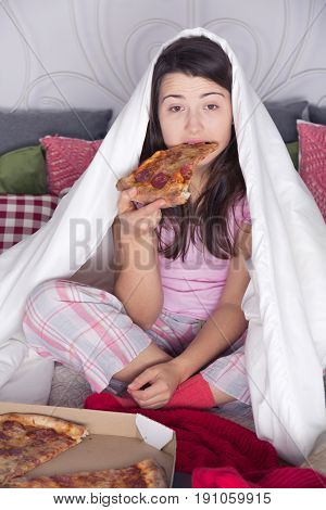 Sad and lonely spinster is night overeating pizza
