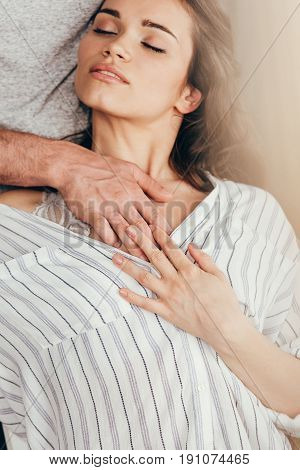 man touching chest of young sensual woman at home
