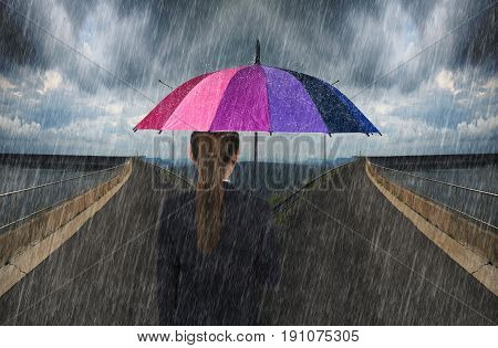 Business Woman Holding Umbrella With Falling Rain On Cross Road Spliting In Two Way