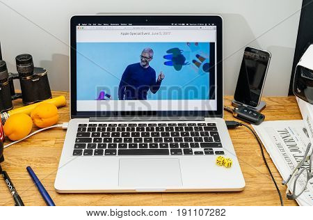 PARIS FRANCE - JUNE 6 2017: Apple Computers website on MacBook Retina in creative environment showcasing Tim Cook welcomes developers from 75 different countries WWDC 2017