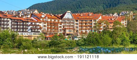 Bansko, Bulgaria - June 13, 2017: St. Ivan Rilski hotel and green pine trees mountains panoramic banner in bulgarian ski resort Bansko