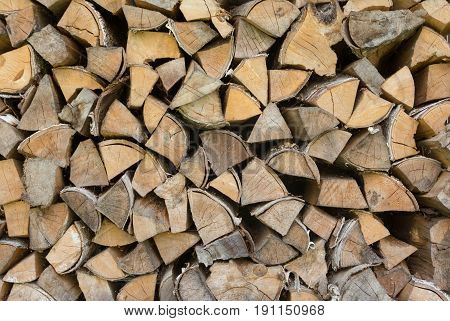 Background of firewood.Stacked Logs Texture, Natural Background. Cross section of the timber.