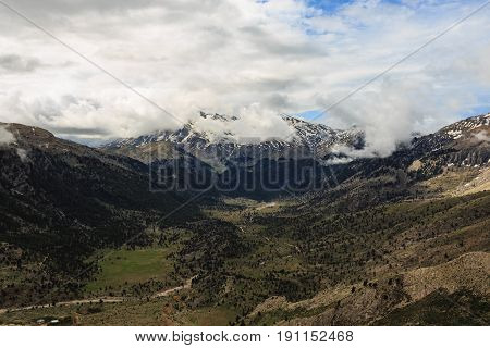Panoramic view of Taurus mountains with meadows pine trees melting snow and clouds
