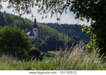 The church of Neukirchen next to Schwandorf in bavaria within a green summer landscape