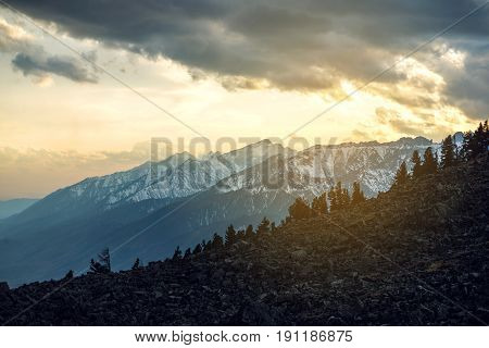 Panorama View Of Spring Landscape Of The Mountains Covered With The Last Snow In A Little Fog And Th