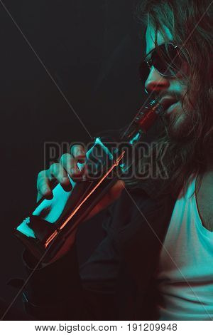 Young Caucasian Drunkard In Sunglasses Drinking Whiskey From Bottle