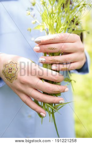 Bouquet of wild flowers in the hands of a girl