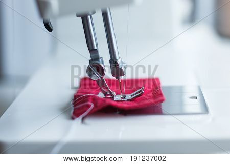 Close-up of modern sewing machine foot. Focus on needle