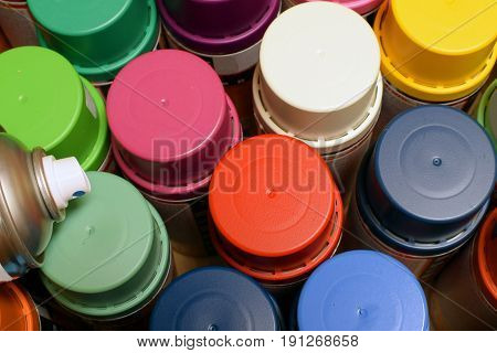 New spray paint cans. View from above.