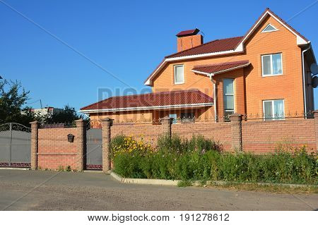 Building brick house construction with different types of attic roof design. Attic construction.