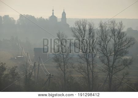 Backlit fall view on russian othodox church on the hill in Roshcha village near Borovsk Kaluga oblast Russia.
