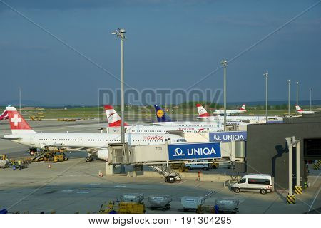 VIENNA, AUSTRIA - APR 30th, 2017: Airplanes of Austrian Airlines, SWISS and Lufthansa parked at the gates in Vienna International Airport. It is the countrys biggest airport, it serves as the hub for Austrian Airlines. Picture was taken from the Austrian 