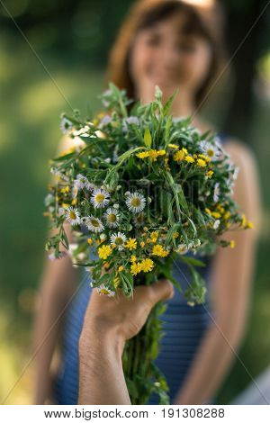 Surprise for girl gift flowers young surprised girl in the park