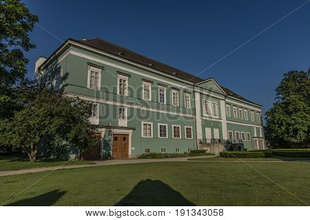 Castle Dacice with green park in spring sunny morning