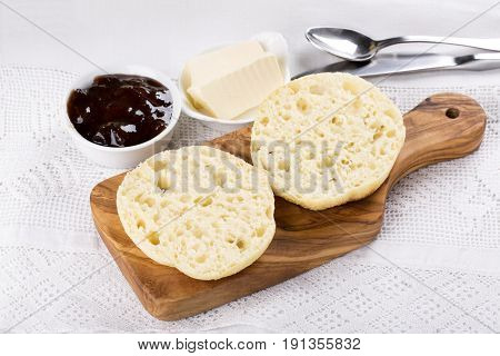 Breakfast. Fresh homemade English muffins with butter and jam