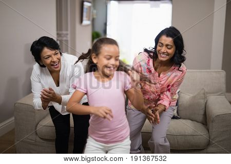 Happy multi-generation family dancing together at home